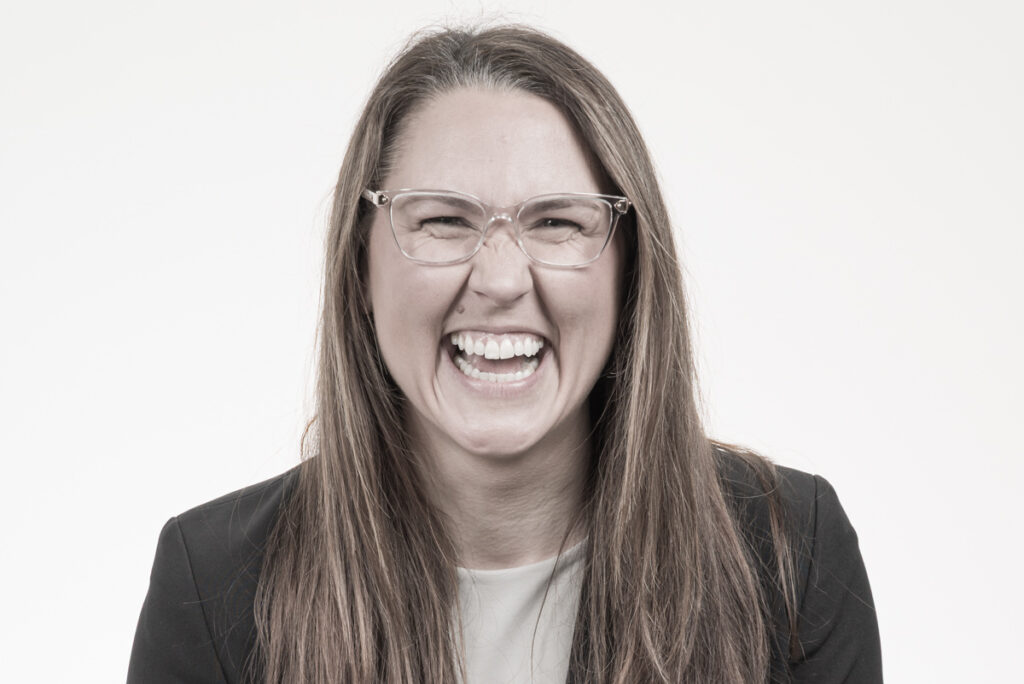 Creative professional portrait showing a muted color headshot of a woman laughing.